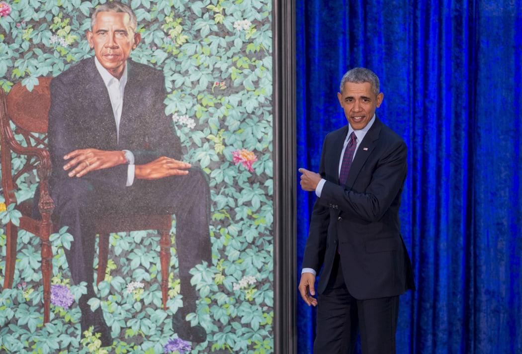 Former US President Barack Obama stands before his portrait by artist Kehinde Wiley after its unveiling at the Smithsonian's National Portrait Gallery.