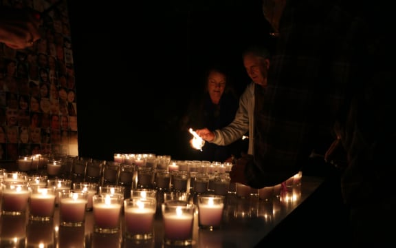 Kim Annan (centre) lights a candle for Stephen Wright with other friends and family members.