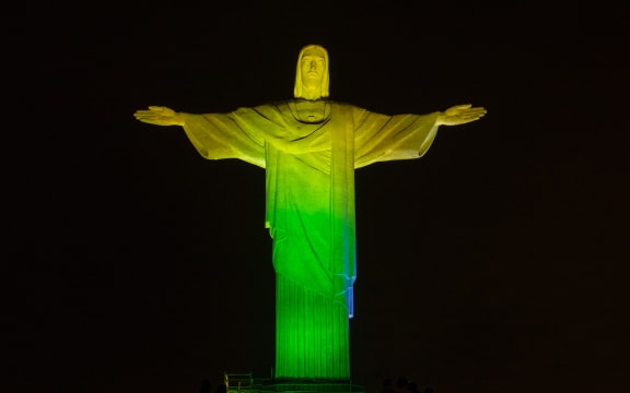 Christ the Redeemer towering over Rio de 
Janeiro was lit with the colours of the Brazilian flag and all participating nations.