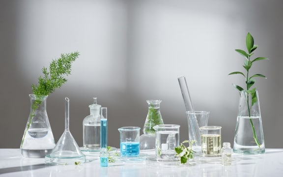 laboratory experiment and research with leaf, oil and ingredient extract for natural beauty and organic skincare product the blank bottle for label ,bio science concept. alternative medicine. spa.