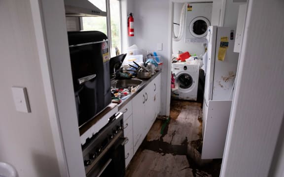 Residents on Comphora Place in West Auckland's Ranui are picking up the pieces at their homes after the Momutu Stream overflowed and flooded their properties.