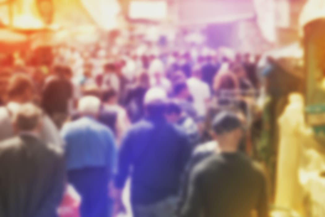 Blurred Crowd of People On Street, unrecognizable crowded population as blur urban background, Vintage Toned Image.