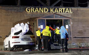 Search and rescue teams work at the site of a fire that broke out in a hotel in the Kartalkaya Ski Resort in Bolu, northwestern Turkey, on January 21, 2025. The number of dead from the fire that engulfed the hotel rose to 66, the interior minister said on January 21, 2025.