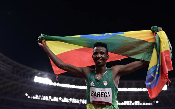 Ethiopia's Selemon Barega celebrates after winning  the men's 10000m final during the Tokyo 2020 Olympic Games at the Olympic Stadium in Tokyo on July 30, 2021.