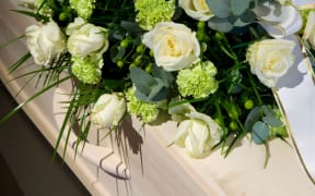 A coffin with a flower arrangement