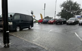Flooding at a block of shops on Don Buck Road in Massey, West Auckland.