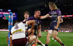Will Warbrick of the Storm celebrates scoring a try with team mates during the NRL Grand Final match between the Brisbane Broncos and the Melbourne Storm at Accor Stadium.