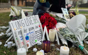 Flowers and messages honouring Chol Achiek and Dau Akueng.