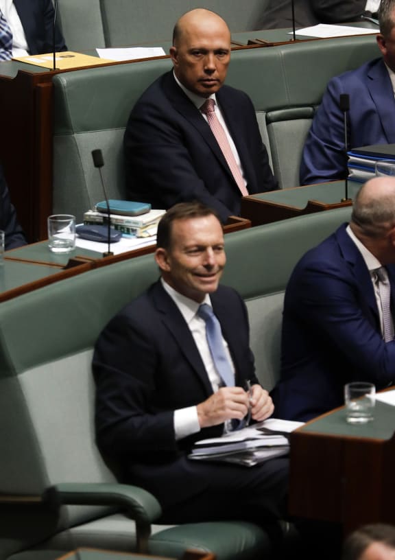 Australia's former home affairs minister Peter Dutton sits on the back bench above former prime minister Tony Abbott in the House of Representatives in Canberra.