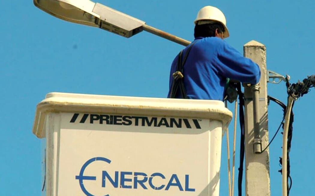 Enercal worker on power line maintenance job.