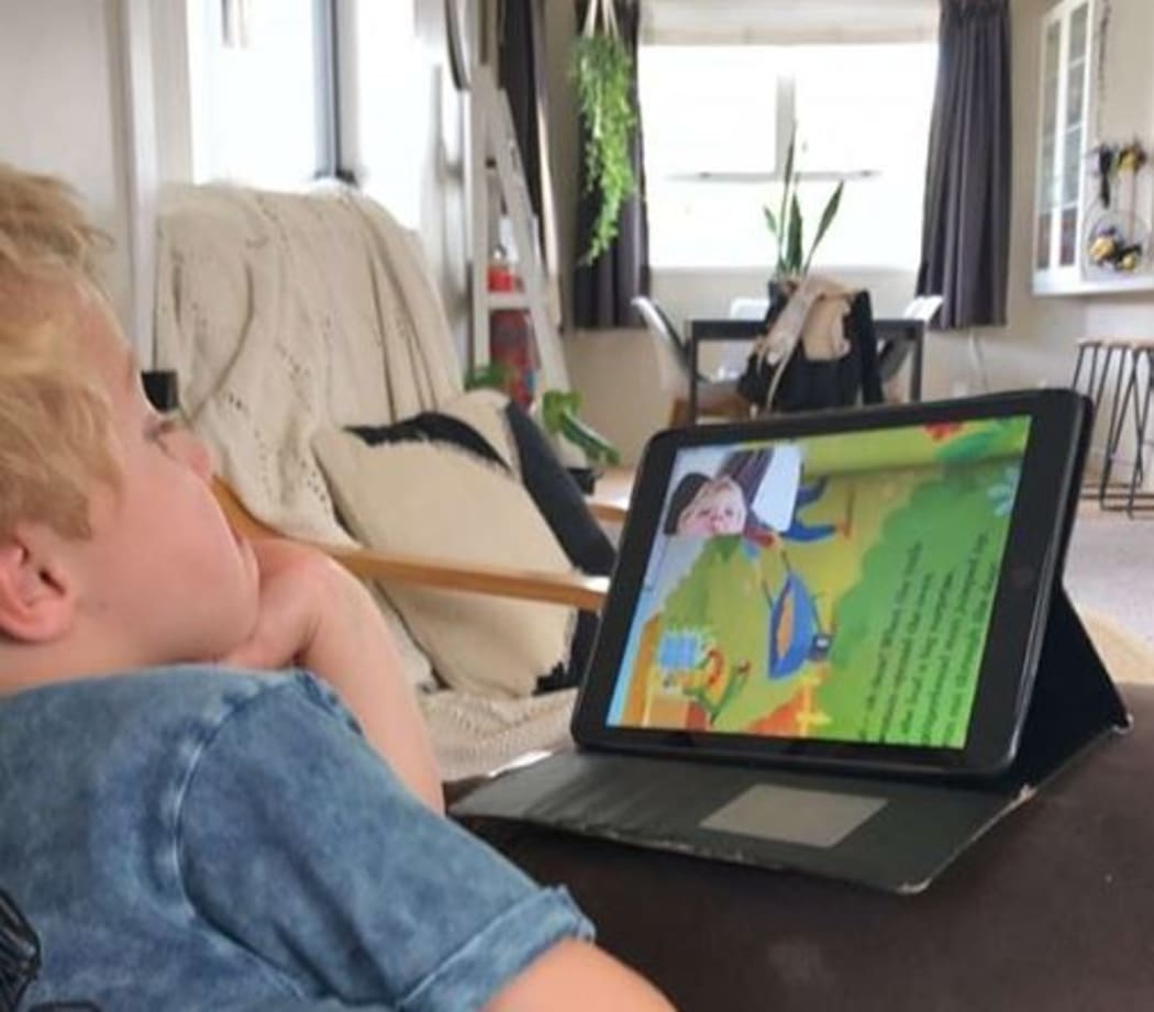 Karen Orr reading her grandchild a book.
