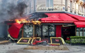 A restaurant on fire during clashes between riot police and 'gilets jaunes' on the Champs-Elysees, Paris on 16 March.