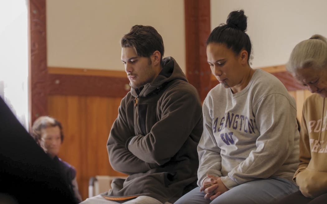 KaHana and mum listening to kōrero in wharenui