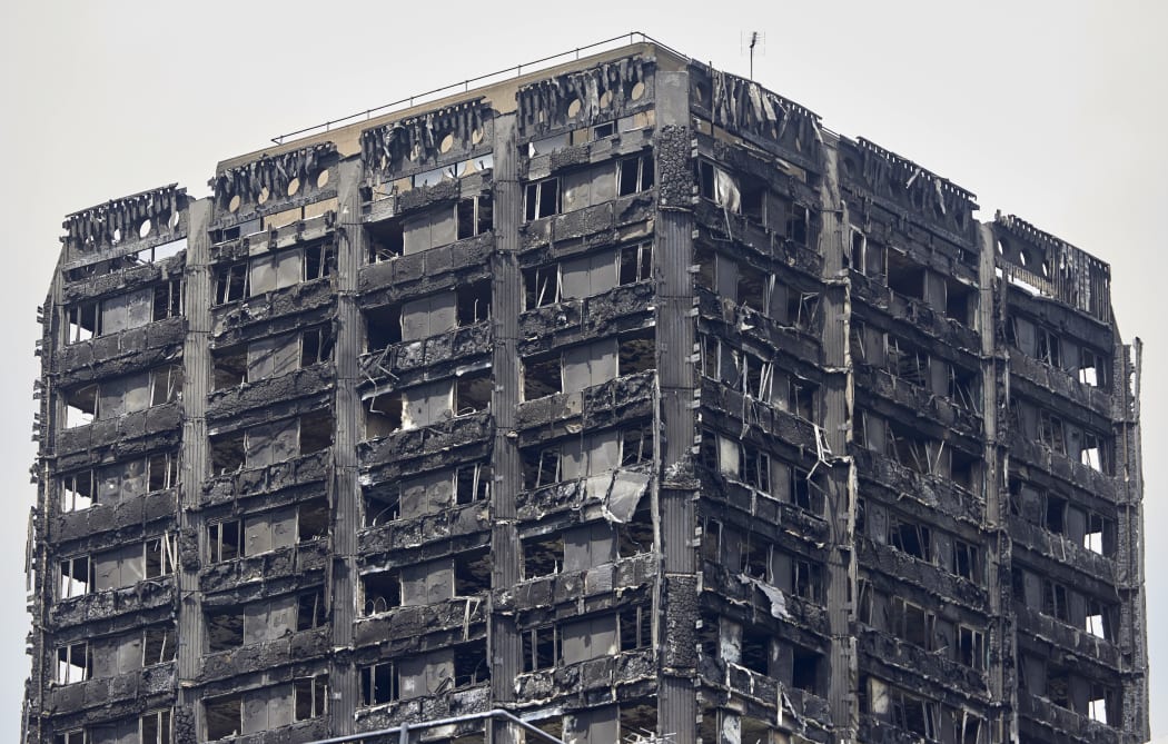 The charred remains of cladding are pictured on the outer walls of the burnt out shell of the Grenfell Tower block in north Kensington, west London, on June 22, 2017.