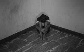 Child with head in hands