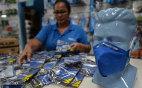A worker at a medical supply store organizes PFF-2 respirator mask that customers are buying as a precaution against the spread of the new coronavirus, the COVID-19, in Sao Paulo, Brazil, on February 27, 2020.
