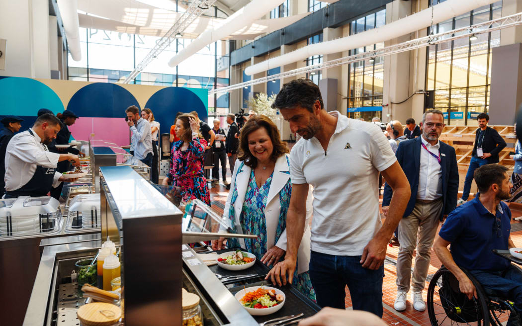 French President of the Paris 2024 Olympics and Paralympics Organising Committee (Cojo) Tony Estanguet (R) and Nathalie Bellon-Szabo, CEO of Sodexo Live! worldwide (L) choose their meal during a test event of the Paris 2024 Olympic and Paralympic Village Restaurant located at the Cite du Cinema in the Olympic Village in Saint-Denis on June 25, 2024.