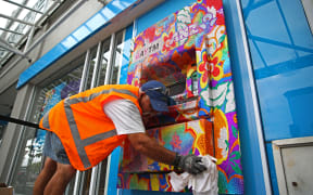 A contractor cleaning up the vandalised ATM in Ponsonby Road, Auckland.