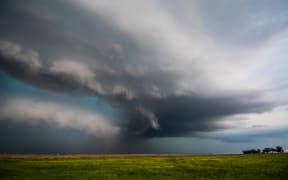 A supercell storm assumes a green colour after producing tornadoes near Felt, Oklahoma