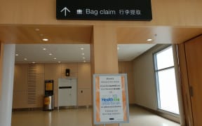 Coronavirus warnings at the Auckland Airport arrival area.