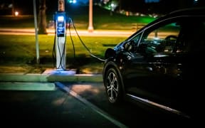 An electric vehicle being charged.