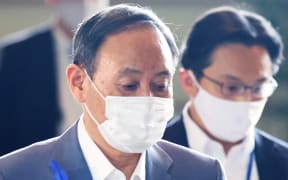 Japan's Prime Minister Yoshihide Suga wearing a face mask amid continuing worries over Covid-19 in July.