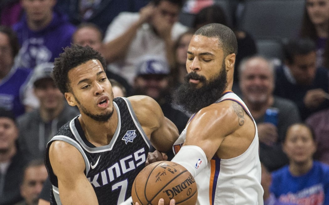 The Sacramento Kings' Skal Labissiere  is defended by the Phoenix Suns' Tyson Chandler.