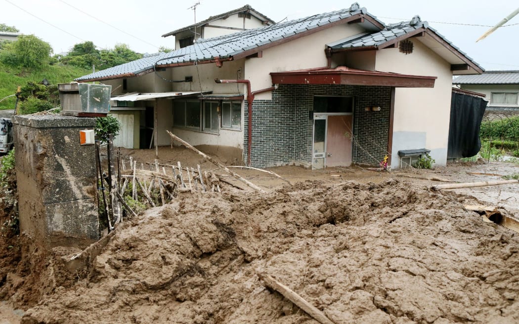 Several houses in Kumamoto in southern Japan have been inundated by mudslides after heavy rain.