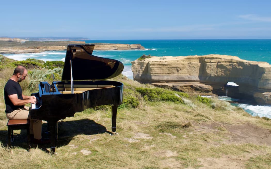 Kelvin Smith performs on a clifftop.