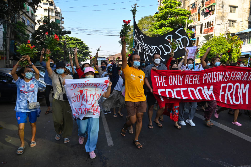 Protesters hold banners as they take part in a demonstration against the military coup in Yangon December 5, 2021.