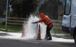 A contractor tries to tame a leak in Carterton.