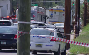 This video grab shows police cars on the site of a shooting in Jacksonville, Florida, 26 August, 2023. A white man driven by racial hatred shot dead three Black people in a Florida discount store on August 26 before taking his own life after a standoff with police, authorities said.