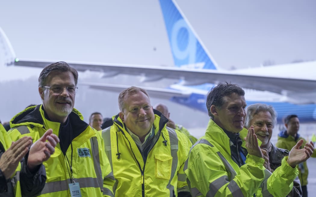 Boeing CEO Stan Deal (C) smiles as stands in a crowd in a hangar at Boeing Field following the first flight of the Boeing 777X airliner on January 25, 2020 in Seattle, Washington.