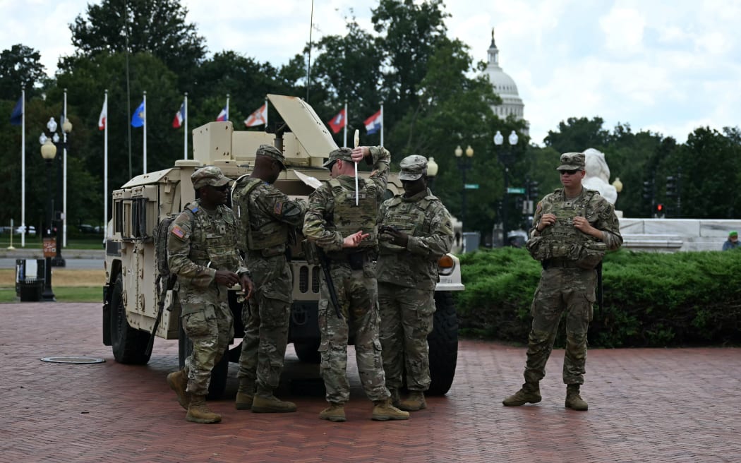 Members of the US National Guard patrol at Union Station in Washington, DC, on August 14, 2025. US President Donald Trump on August 11 deployed military and federal law enforcement to curb violent crime in Washington, as he seeks to make good on his campaign pledge to be a "law and order" president. The Republican leader said he would place the city's Metropolitan Police under federal government control while also sending the National Guard onto the streets of the US capital. (Photo by Jim WATSON / AFP)
