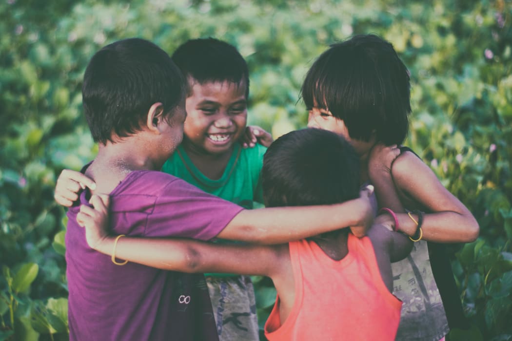 four children hug