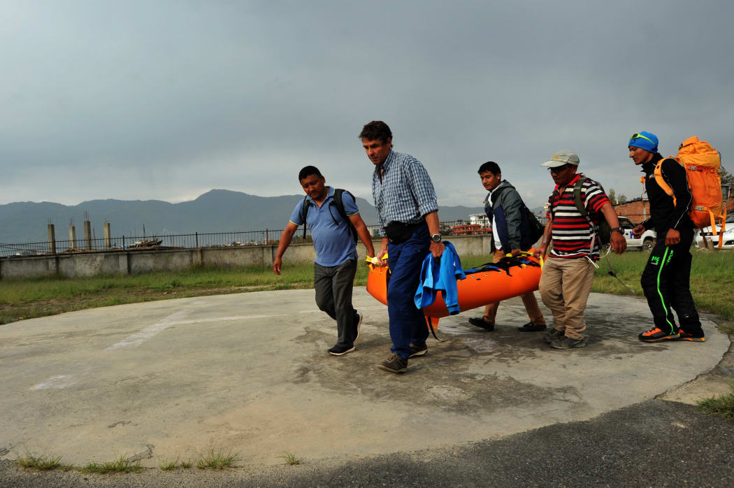 Nepalese volunteers and friends of Swiss climber Ueli Steck carry his body at a hospital in Kathmandu after it was recovered by helicopter.