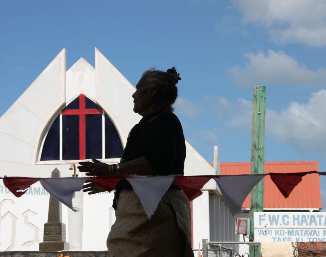 Tongan woman with church behind