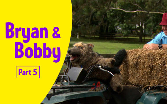 Photograph of Bryan (male adult) and Bobby (realistic large dog puppet) on a quad bike with hay.
Text reads   "Bryan and Bobby Part 5”