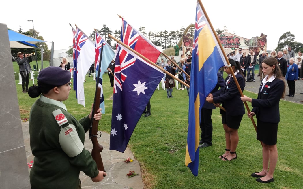 Flags are lowered for the Last Post during the Kerikeri service.