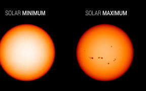 Visible light images from NASA's Solar Dynamics Observatory show the Sun at solar minimum in December 2019 and the last solar maximum in April 2014. Sunspots freckle the Sun during solar maximum; the dark spots are associated with solar activity.