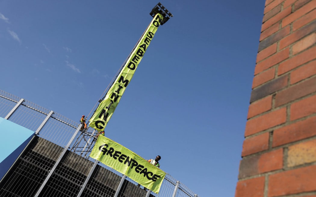 'No Seabed Mining' sign hanging off Sky Stadium lighting tower.