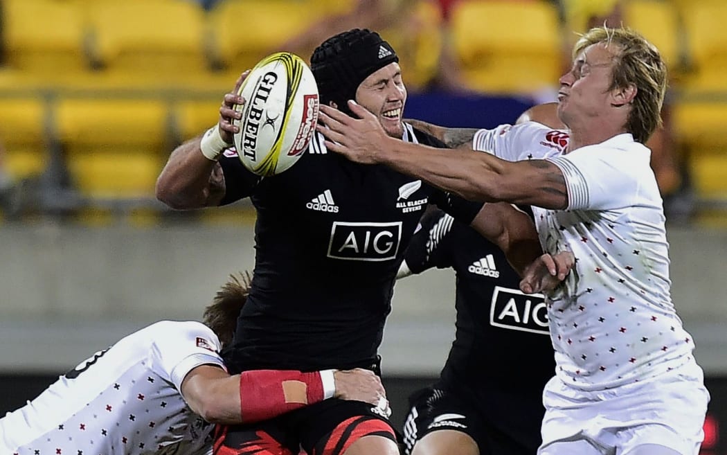 New Zealand's Gillies Kaka (C) is tackled by England's Christian Lewis-Pratt (L) and Warwick Lahmert.