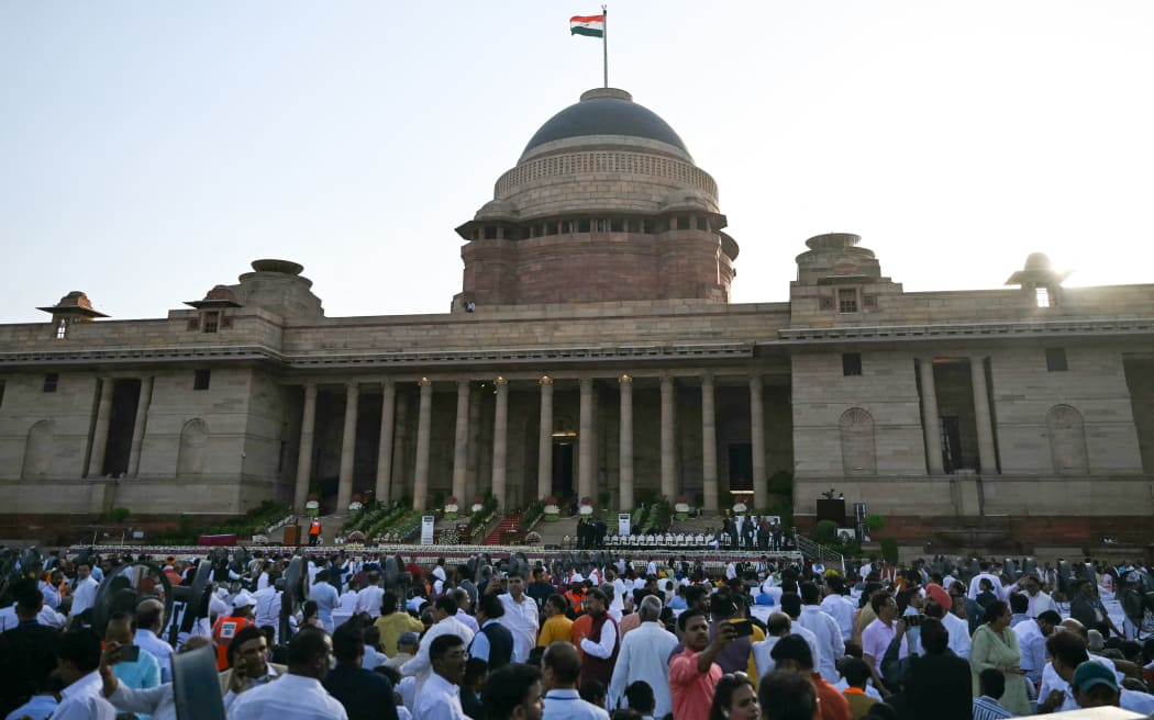 People gather ahead of the oath-taking ceremony of India's prime minister and council of ministers at the presidential palace Rashtrapati Bhavan in New Delhi on June 9, 2024.