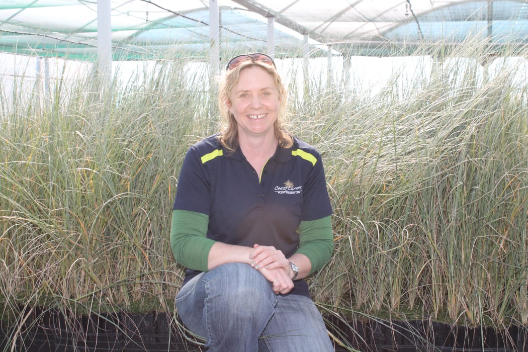Horticulturalist Jo Bonner, in front of hundreds of spinifex plants growing in a shade house at Coastlands Plants.