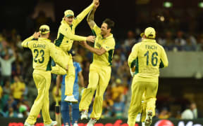 (From left) Australia's Michael Clarke, Steven Smith, Mitchell Johnson and Aaron Finch celebrate the wicket of India's Ravindra Jadeja during the 2015 Cricket World Cup semi-final match between Australia and India in Sydney on March 26, 2015.