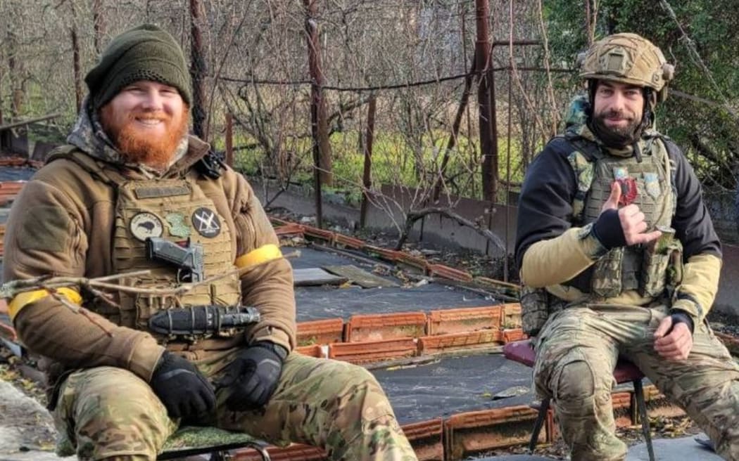 Jordan O'Brien (left), a former New Zealand soldier fighting in Ukraine, relaxes with a colleague.