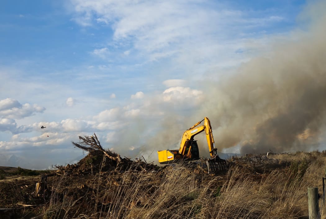 A digger takes part in the fight against the Lake Ohau fire