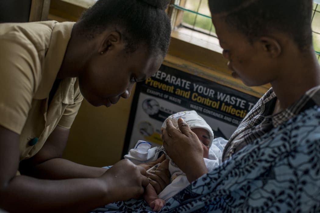 A baby receives vaccine at the maternity ward of the Ewin Polyclinic in Cape Coast, Ghana, in 2019. After Malawi, Ghana was the second country to launch the vaccine known by its lab initials as RTS,S but branded Mosquirix.