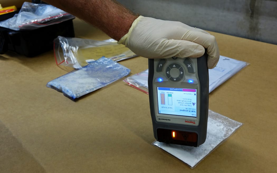 A customs official does a quick test for illicit drugs using the "First Defender" tool - which is a small device that can check for thousands of narcotics in seconds