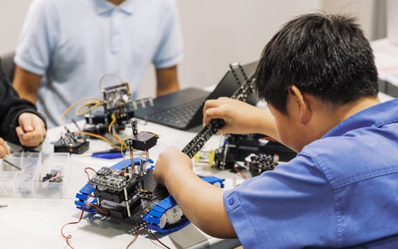Young students learn technology, science, and engineering through fun and hands-on experiences by building a robot.